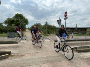 Cyclists cycling alongside the busway